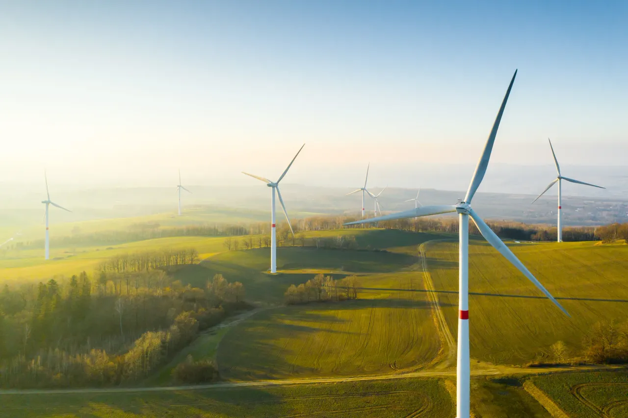 Wind turbines spread across hilltops, assessed in a wind farm assessment report